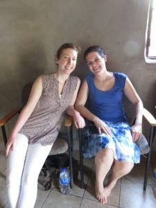 Two women, Grace and Gaby, visiting women in their  in El Salvador.