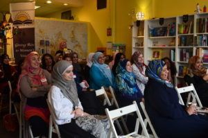 Audience seated at a bookstore in Minneapolis during RISE event.
