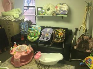 Photograph of baby bouncers, baby bathtub, carseat, and changing stations.