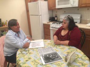 Gilda of ESPERA program and Maria Guadalupe of grantee CREA chatting at the kitchen table.