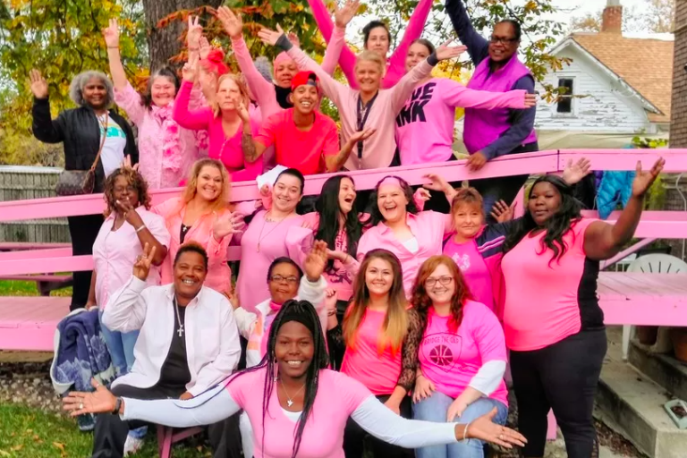 Group photo of Emmaus House Women & Staff all wearing pink